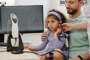 Child undergoing a hearing test with an audiologist in Wenatchee, WA, to ensure healthy auditory development and effective communication.